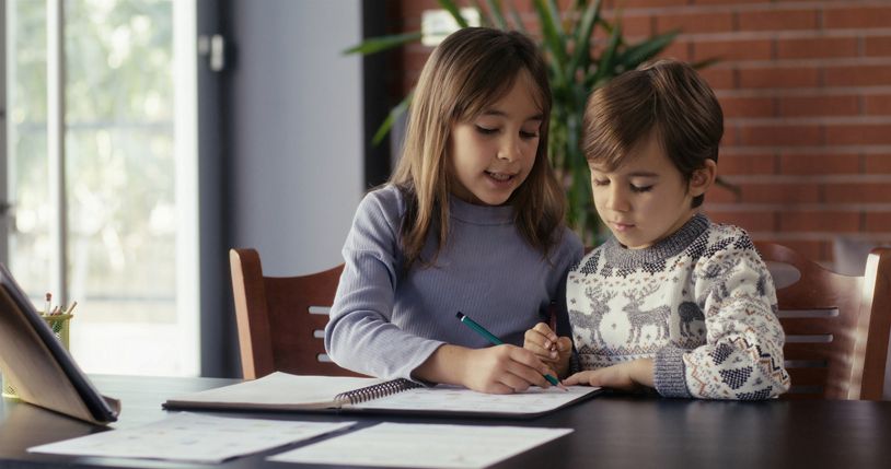 Older Sibling Helping Younger Sibling with Homework