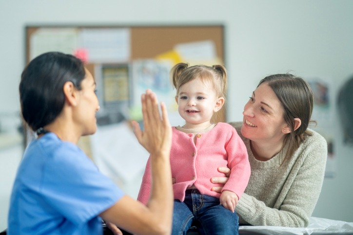 Therapist Guiding Toddler and Caregiver to Encourage Communication