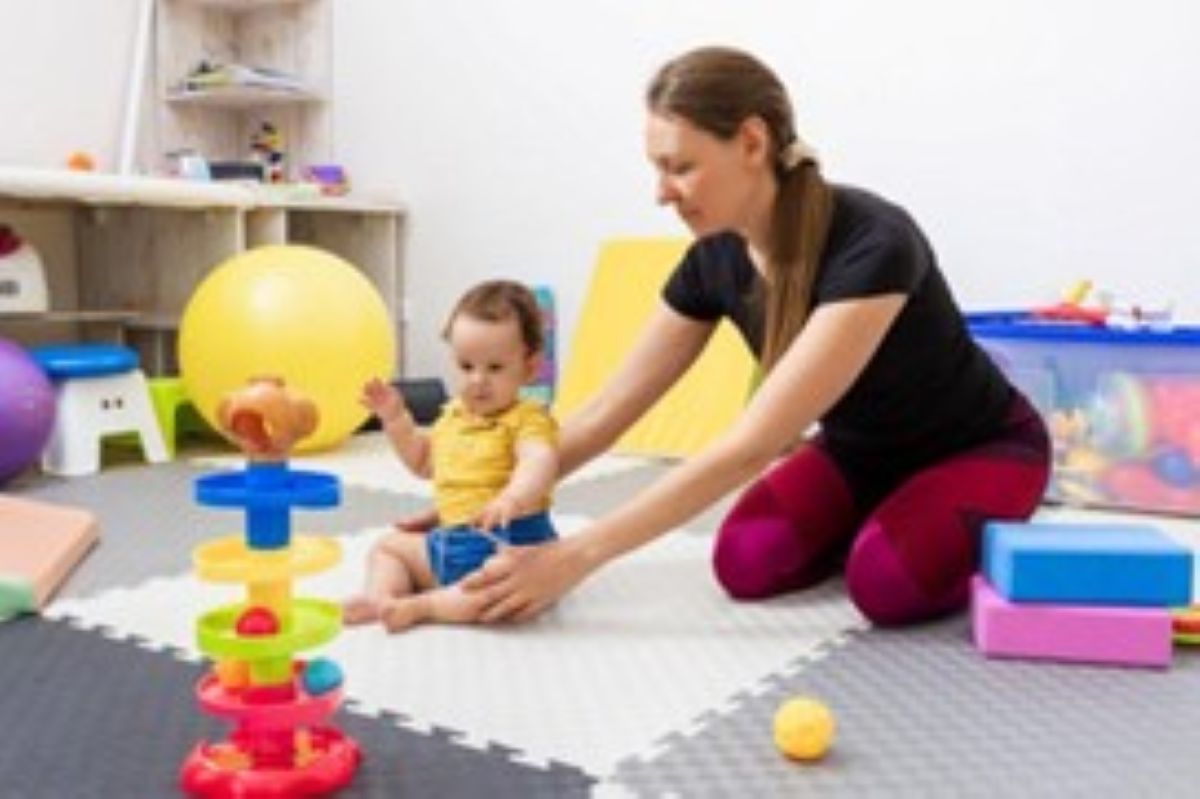 ABA Therapist Assisting a Little Child with Coordination