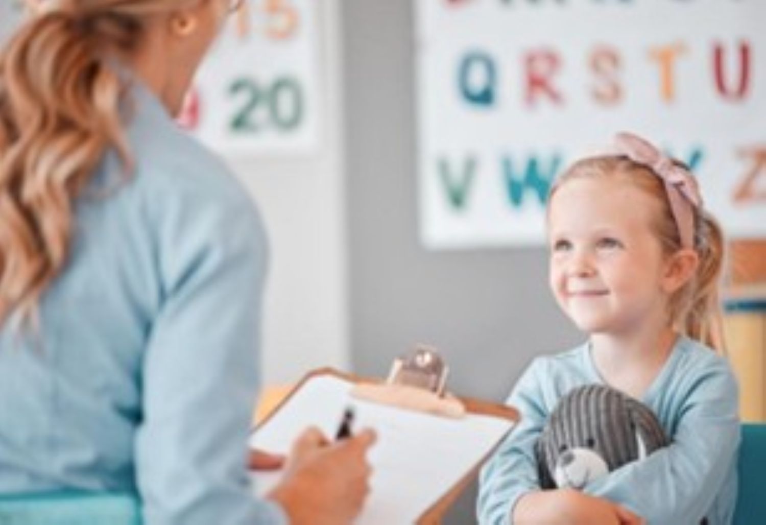 Child Sitting with her ABA Therapist in a Clinic