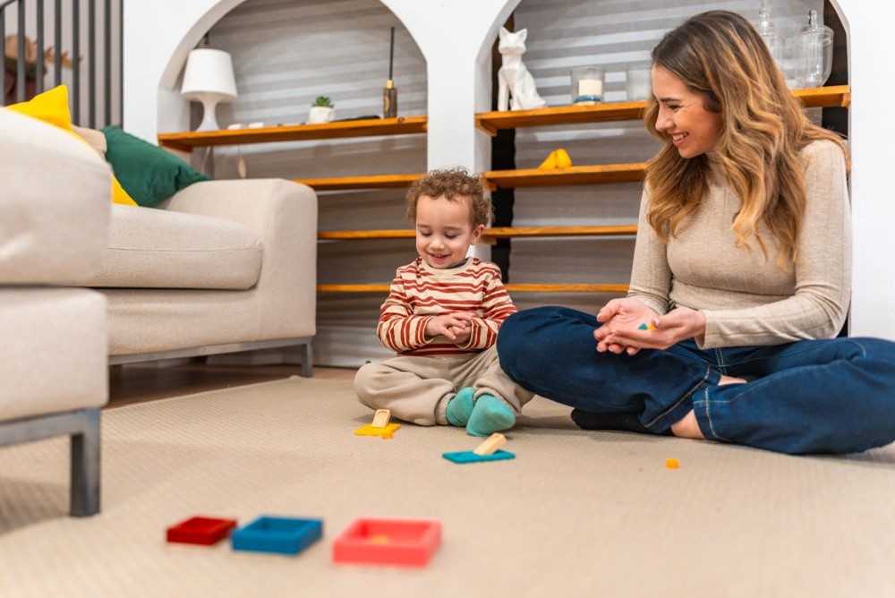 ABA therapist and child playing learning puzzle toys together