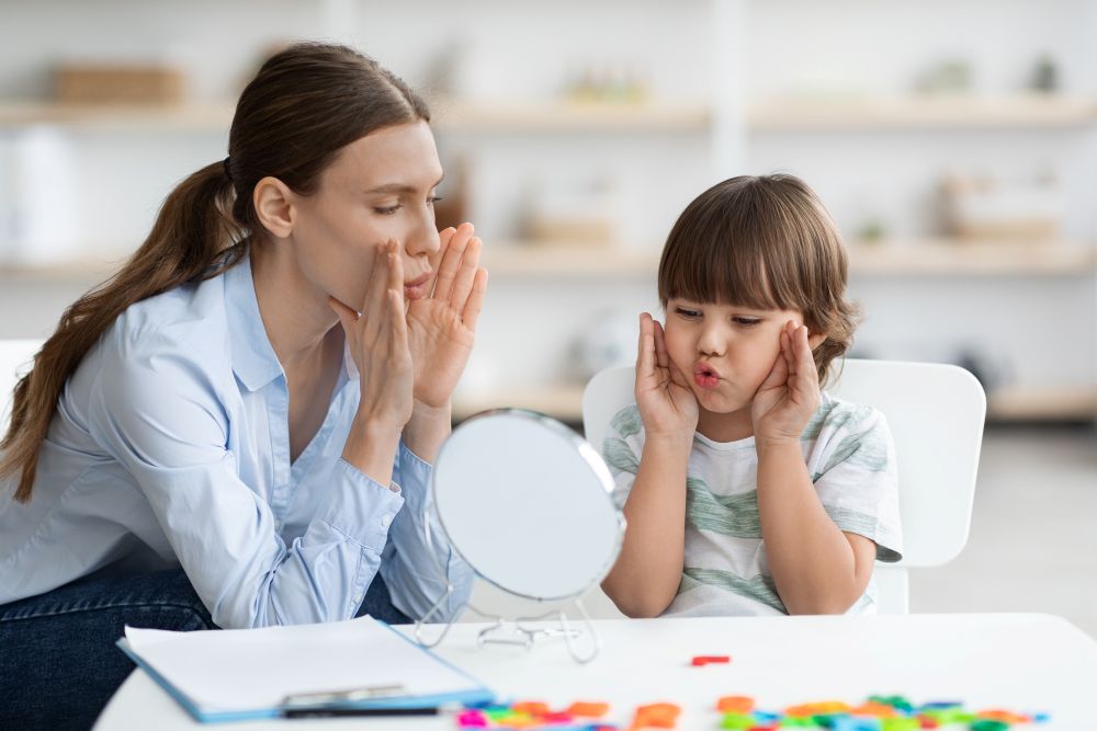 Little Boy with Speech Problems Practicing with Therapist