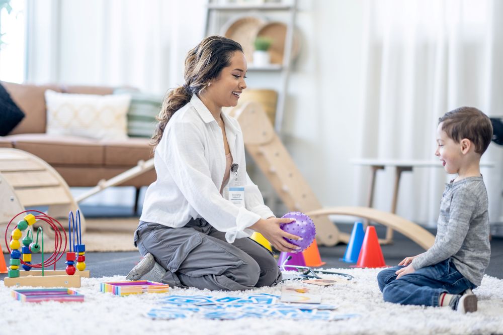 Female Therapist Providing Play-Based ABA Therapy to a Child