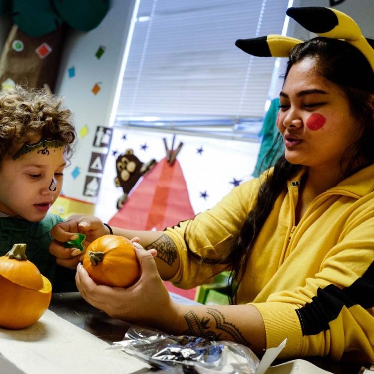 Therapist working one-on-one with young child during early autism support session